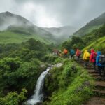 Monsoon trekking trail Western Ghats near Mumbai hikers climbing green mountain path waterfall misty clouds