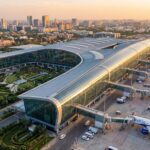 Aerial view of Navi Mumbai International Airport terminal with IndiGo and Air India planes at boarding gates