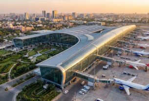 Aerial view of Navi Mumbai International Airport terminal with IndiGo and Air India planes at boarding gates