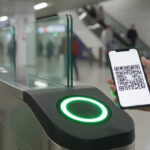 Passenger scanning a WhatsApp QR code ticket at Navi Mumbai Metro AFC gate.