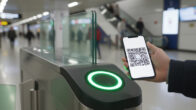 Passenger scanning a WhatsApp QR code ticket at Navi Mumbai Metro AFC gate.