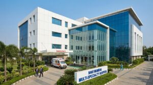 Modern multi-specialty hospital building exterior in Navi Mumbai with emergency entrance and landscaped surroundings