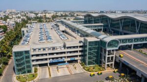 Navi Mumbai International Airport NMIA multi-level car parking facility with terminal building in background