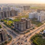 Aerial view of Navi Mumbai real estate development with under-construction towers and completed residential complexes