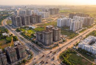 Aerial view of Navi Mumbai real estate development with under-construction towers and completed residential complexes
