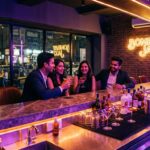 Stylish lounge bar in Navi Mumbai with ambient lighting, cocktails on the counter, and a lively evening crowd