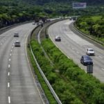 Car driving on the Mumbai-Pune Expressway through the Sahyadri hills