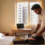 Best PG and Flatmate Options in Navi Mumbai 2026: Area-Wise with Rent Ranges 10 Young professional settling into a PG accommodation room in Navi Mumbai