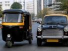 A black-and-yellow auto rickshaw and a black-and-yellow taxi parked on a street in Navi Mumbai