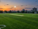 Illustrative AI-generated image of a turf sports ground at dusk. Does not depict a specific Navi Mumbai venue.
