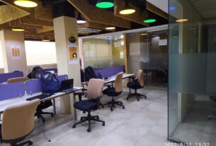 Empty open-plan coworking desks and chairs in a generic shared workspace, used here as an illustrative image and not a photo of any specific Navi Mumbai centre
