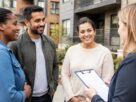 Illustrative image of residents discussing paperwork outside a residential building. Does not depict an actual society or registration.