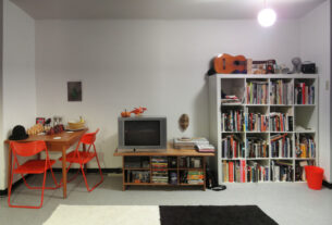 Illustrative photo of an ordinary lived-in apartment living room. Not a photograph of a specific household or research participant.
