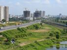 Illustrative AI-generated view of a developing suburban area near a highway and rail line, not an actual Panvel location.