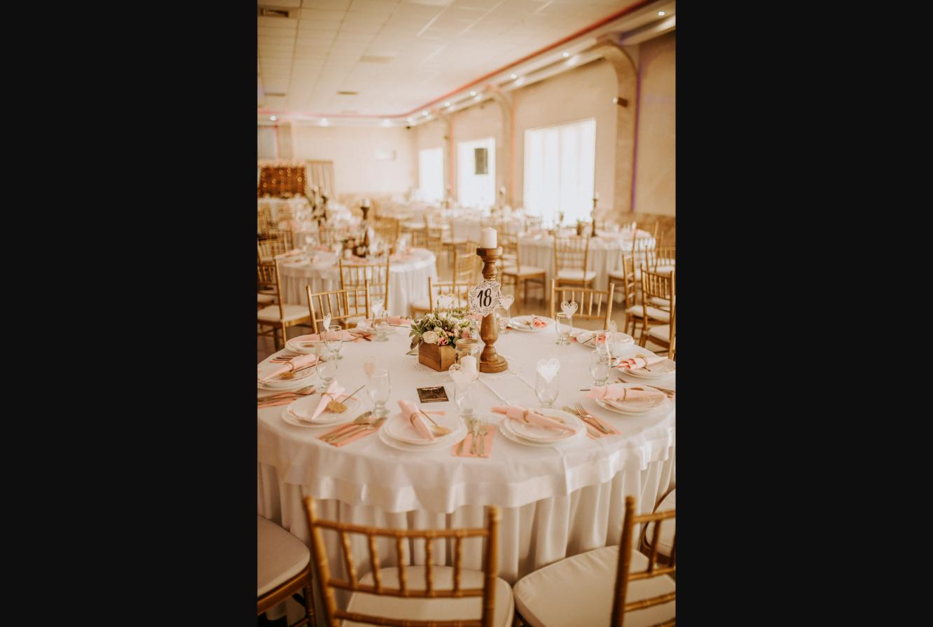 Elegant banquet table setting with floral centerpiece, gold chairs and soft lighting; illustrative image, not a specific Navi Mumbai venue