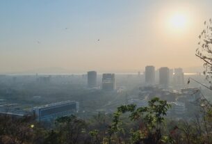 Hazy view of the Navi Mumbai skyline at sunset from a hill