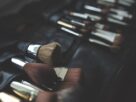 A leather roll holding a row of professional makeup brushes in dim light