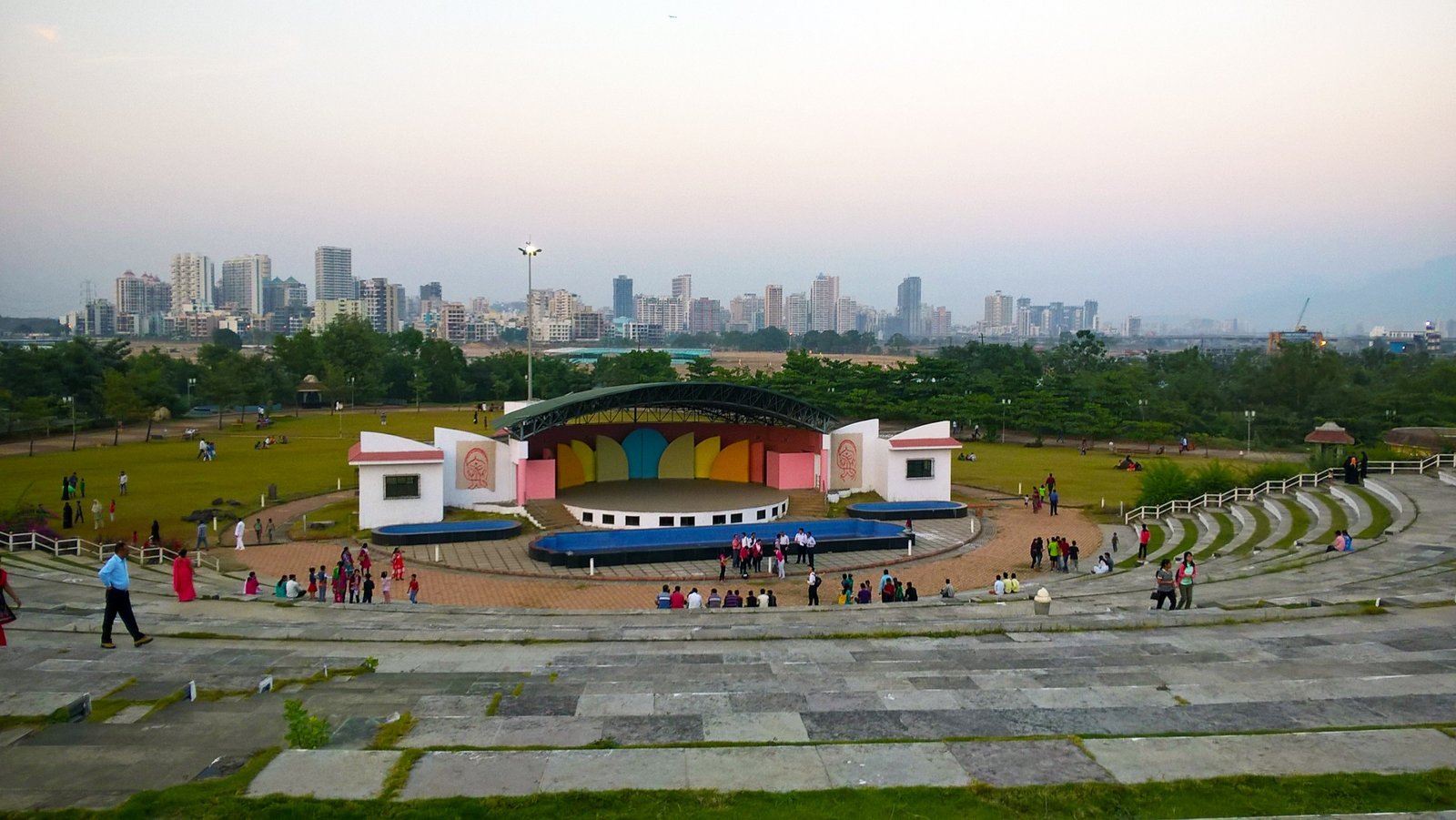 Open-air amphitheatre at Central Park in Kharghar with the city skyline behind