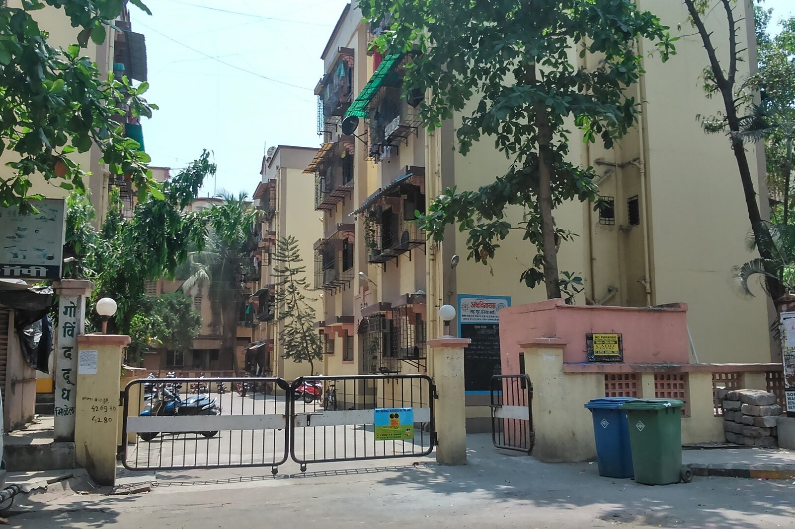 Gate and entrance of a CIDCO flat housing society in Sector 10, Sanpada, with residential buildings and trees behind