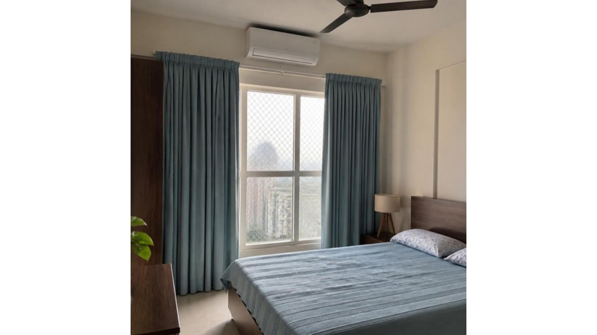Cream walls with dusty blue curtains in an Indian apartment bedroom, AI-generated illustrative render