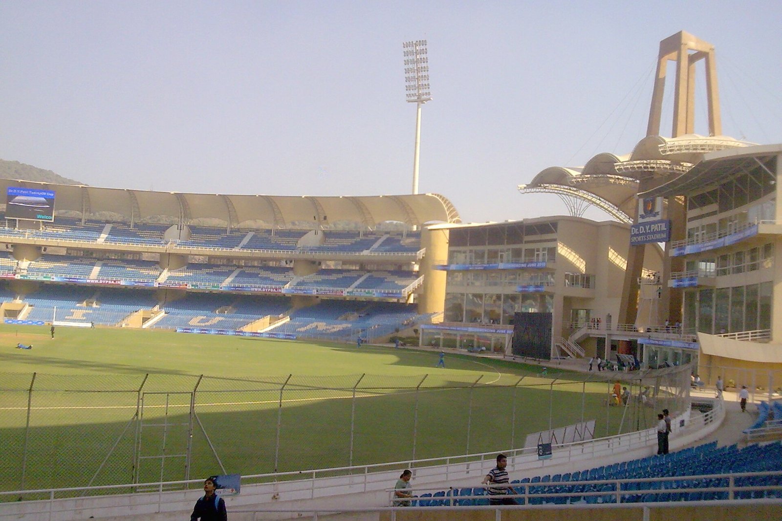 Dr. D.Y. Patil Sports Stadium in Nerul with a floodlight tower, grass outfield and covered stands