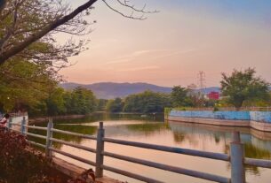 Artificial lake at Central Park in Kharghar at sunset with hills in the background