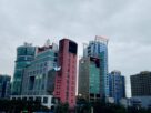 Glass and concrete commercial towers of different heights in Vashi under an overcast dusk sky
