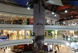 Atrium of Inorbit Mall in Vashi with escalators, shoppers and festive decorations