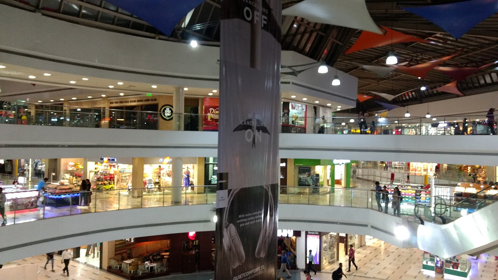 Atrium of Inorbit Mall in Vashi with escalators, shoppers and festive decorations