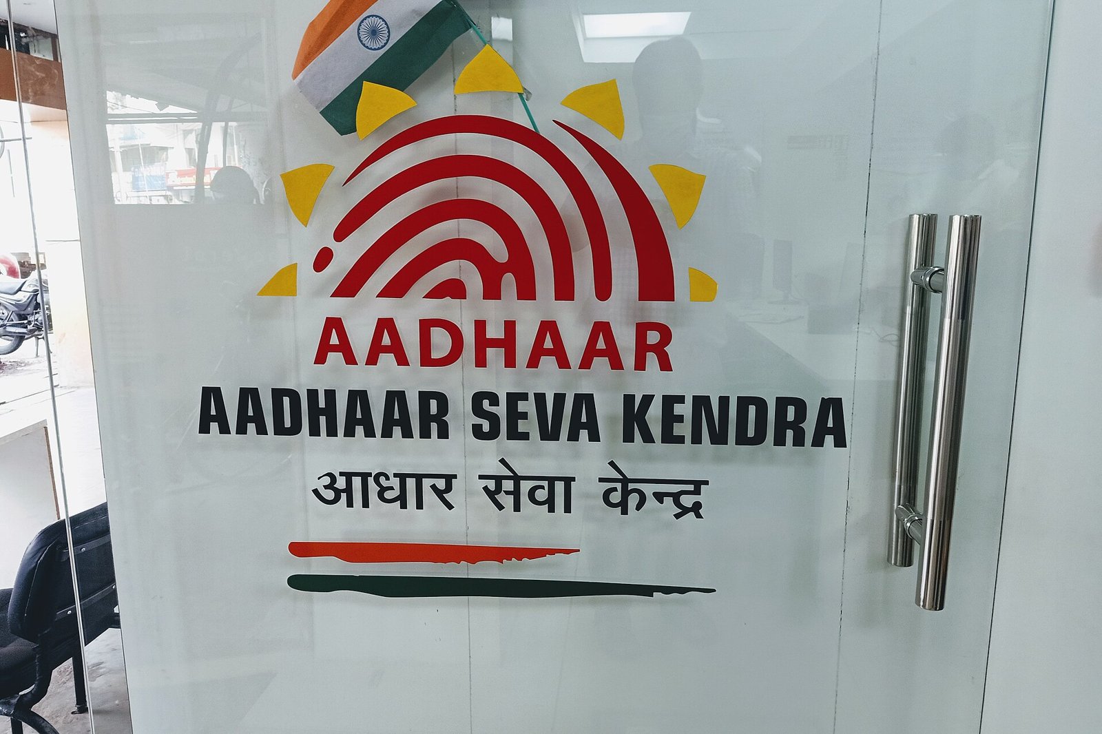 An Aadhaar Seva Kendra counter with applicants