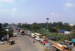 Trucks and buses at a junction on the national highway at Kalamboli