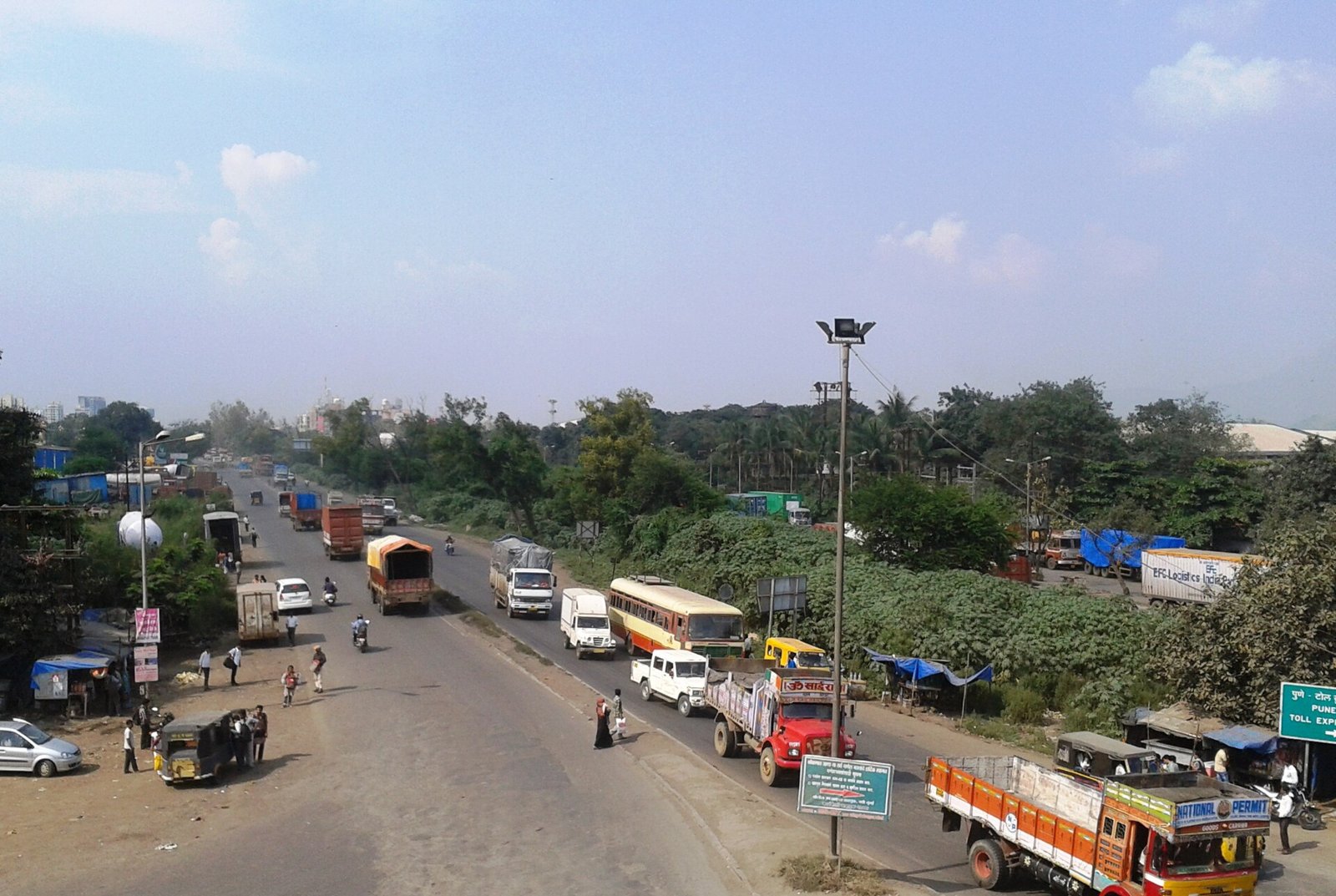 Trucks and buses at a junction on the national highway at Kalamboli