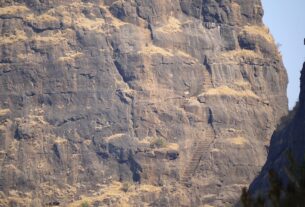 Rock-cut staircase climbing the steep cliff face of Kalavantin Durg