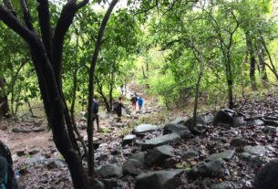 Hikers on a rocky forest trail in Karnala Bird Sanctuary
