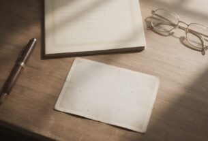 A death certificate, old family photograph, pen and reading glasses arranged on a desk, AI-generated illustrative render