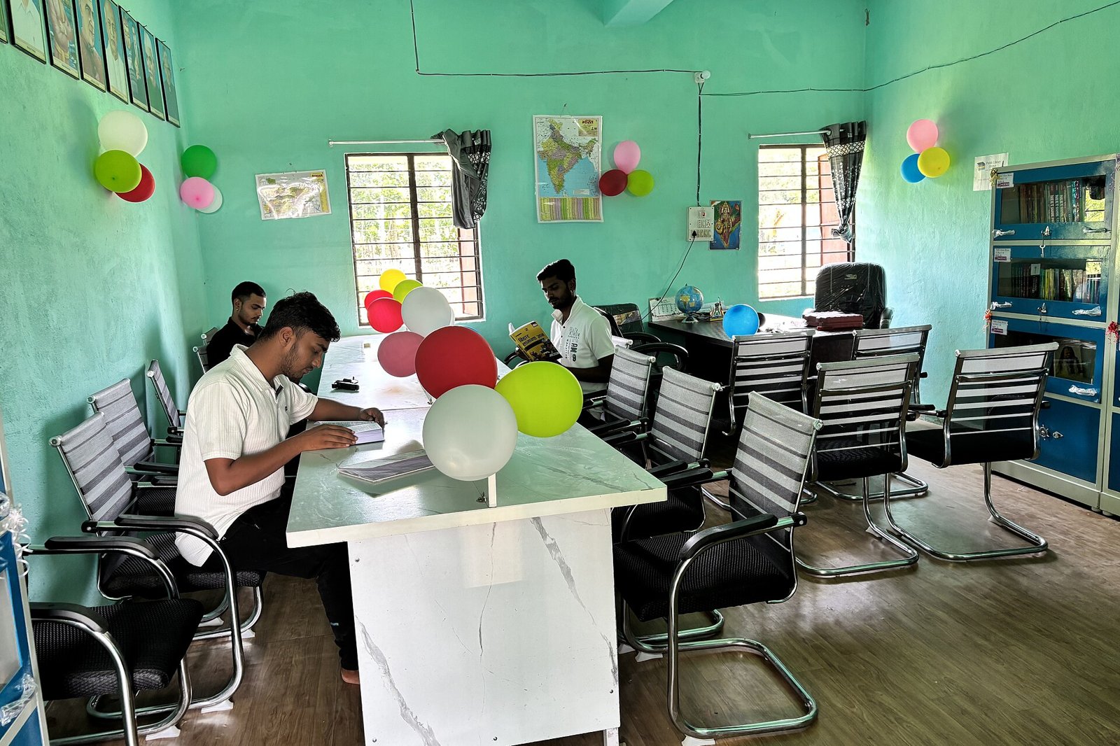 Students reading at desks in a public library reading room