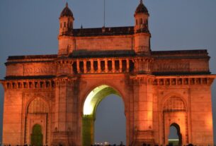 The Gateway of India in Mumbai lit up at dusk
