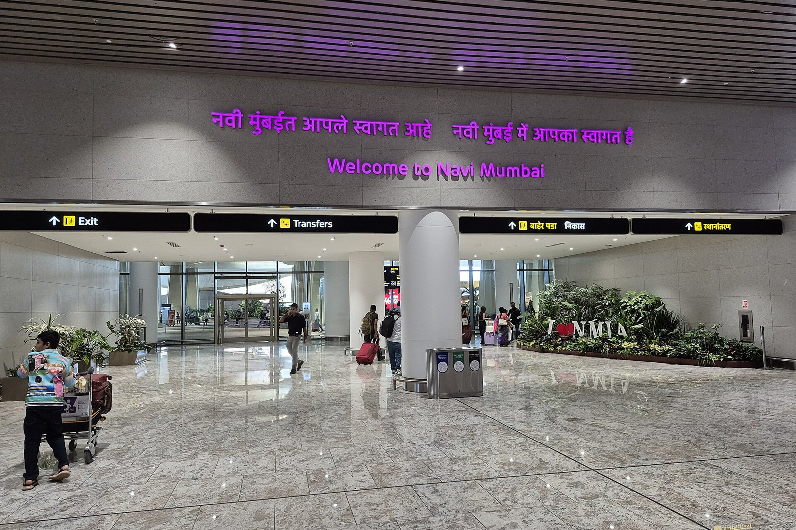 Arrivals area at Navi Mumbai International Airport with a Welcome to Navi Mumbai sign