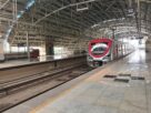 A silver and red Navi Mumbai Metro Line 1 train at the platform of Utsav Chowk station in Kharghar