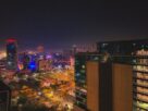 Navi Mumbai skyline at night, with lit towers and an open busy ground below