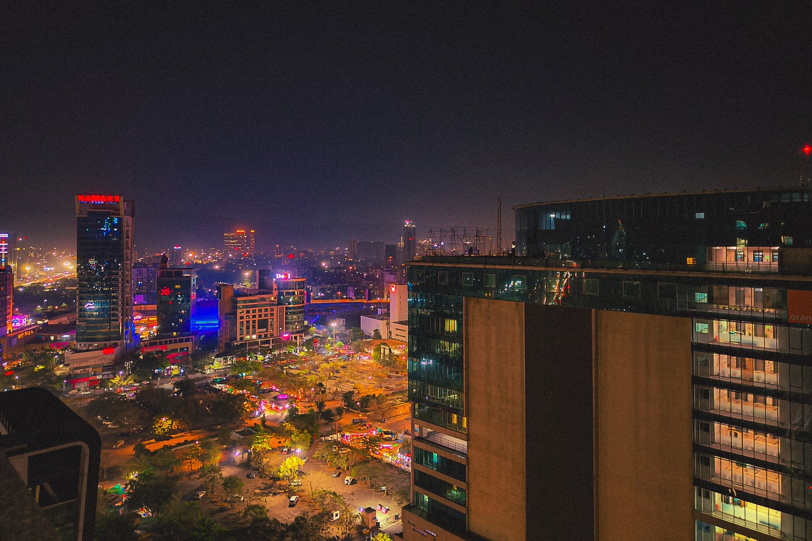 Navi Mumbai skyline at night, with lit towers and an open busy ground below