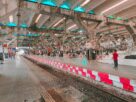 Platform and canopy at Nerul railway station with passengers waiting