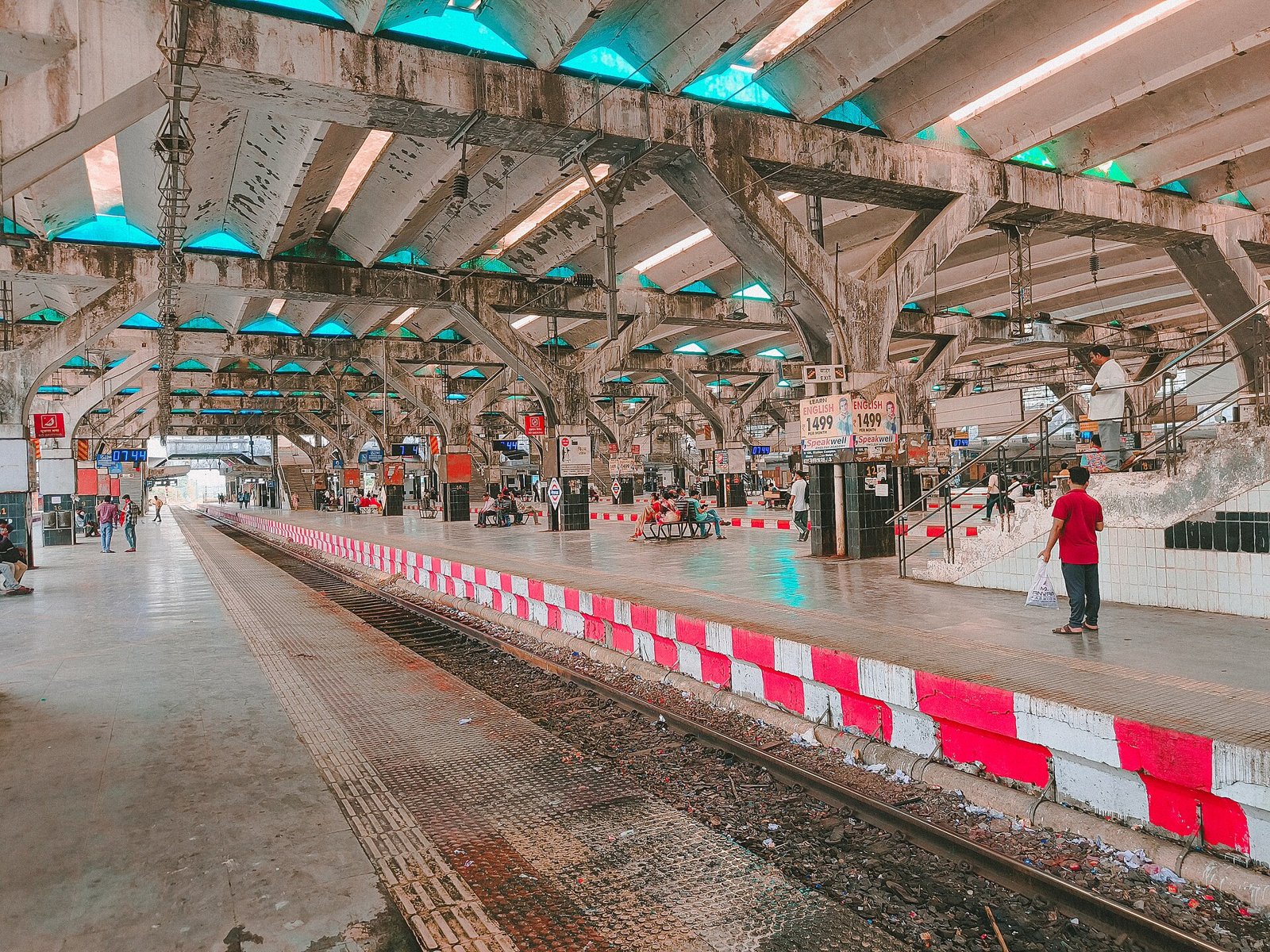 Platform and canopy at Nerul railway station with passengers waiting