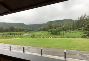 View over the tee at Kharghar Valley Golf Course with green hills behind