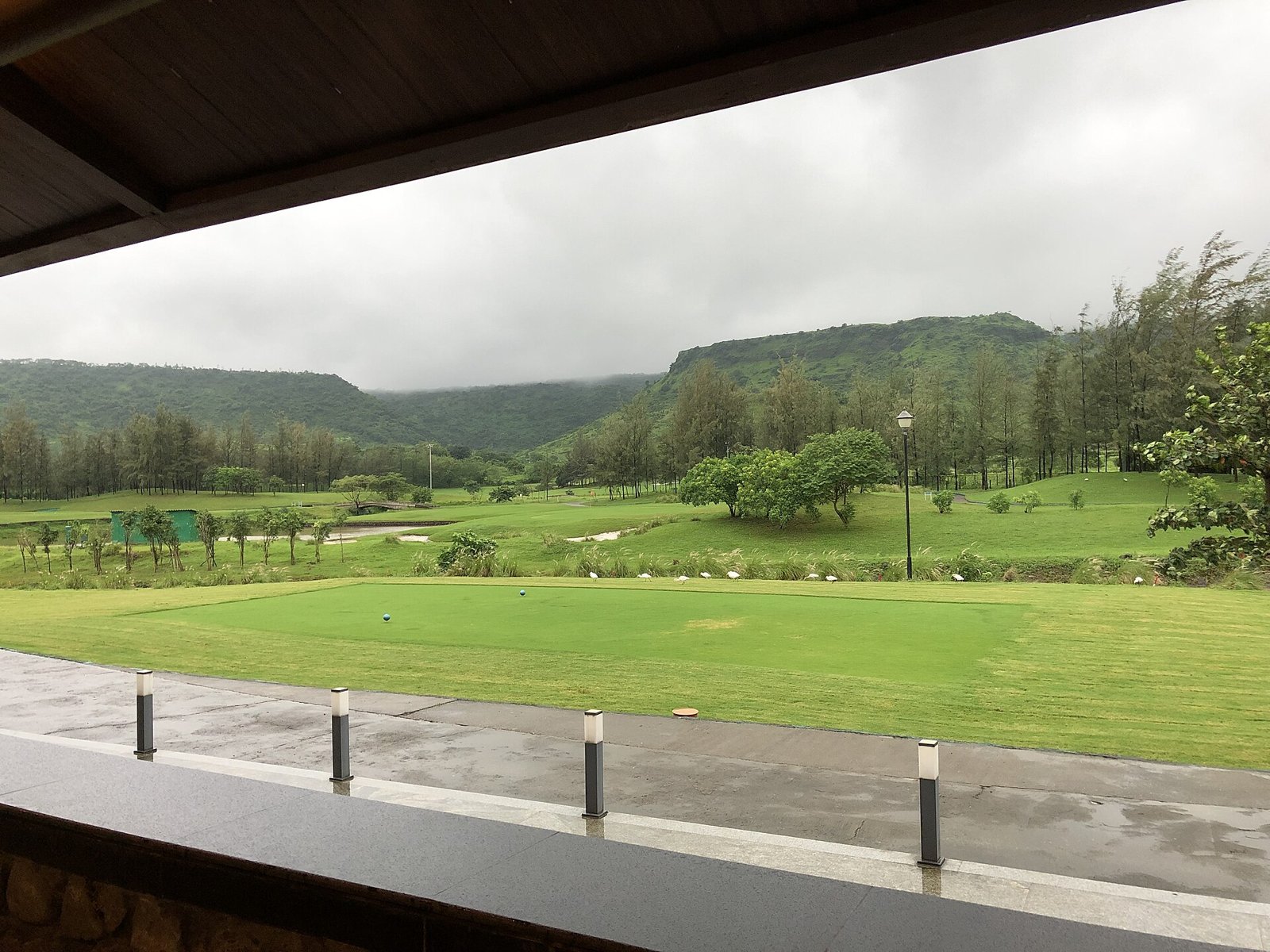View over the tee at Kharghar Valley Golf Course with green hills behind