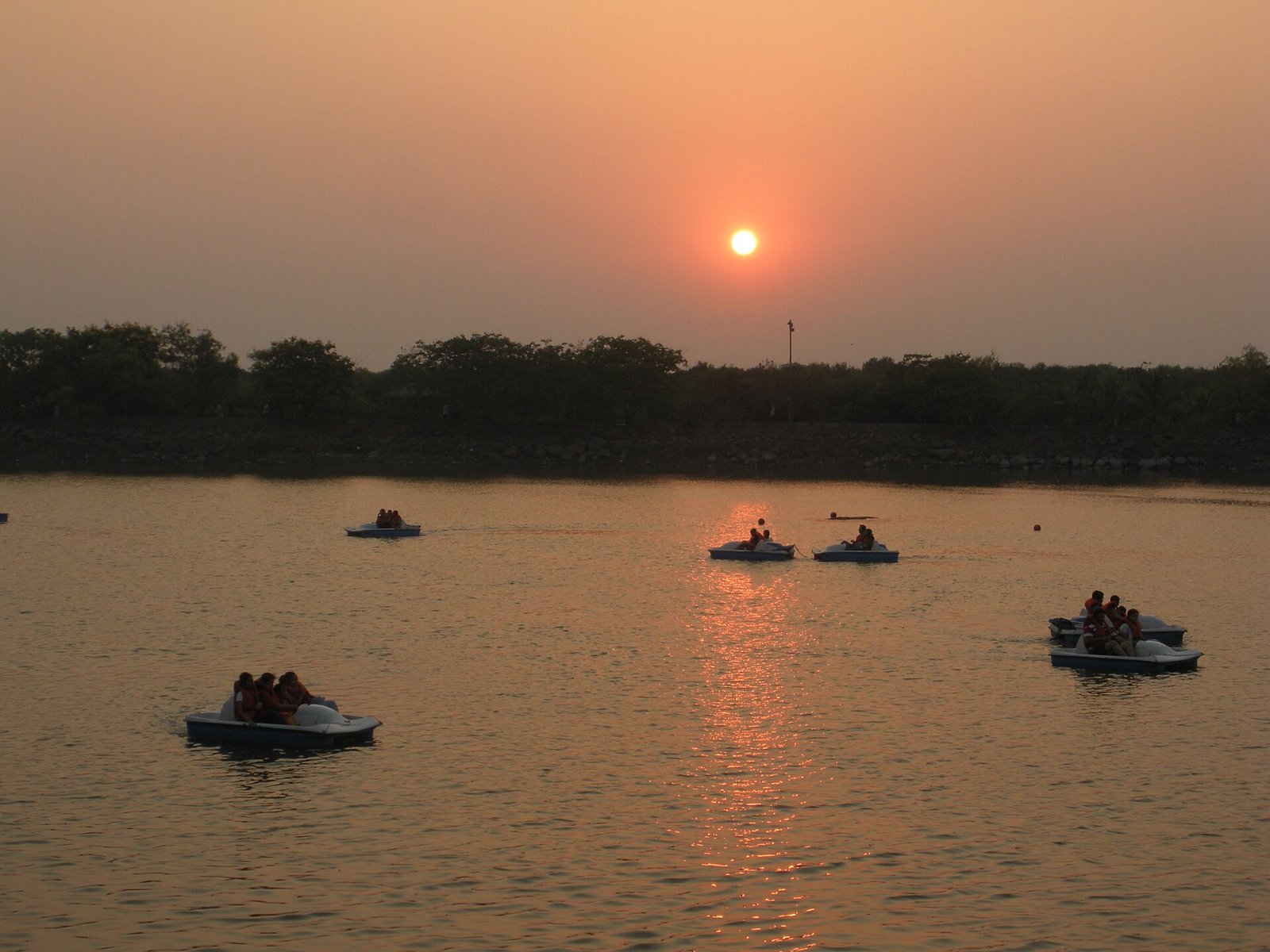 Paddle boats on the lake at Sagar Vihar in Vashi at sunset