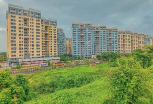 Open green land beside apartment towers in Ulwe, Navi Mumbai