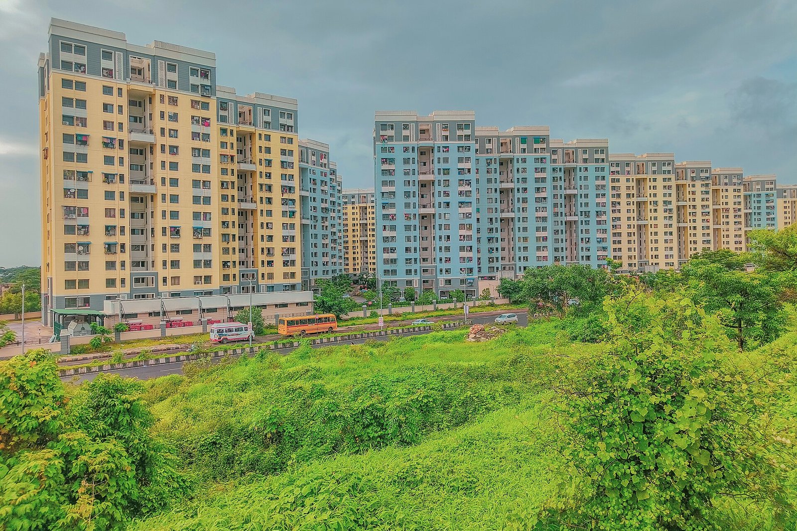 Open green land beside apartment towers in Ulwe, Navi Mumbai