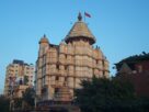 Exterior of the Siddhivinayak Temple in Prabhadevi, Mumbai, against a clear sky