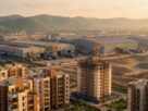 Illustrative AI-generated view of new residential towers beside an industrial belt, not an actual Taloja location.